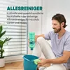 A man is sitting on the floor next to a window, holding a bottle of cleaning product over a bucket. Produktbild-Vorschau