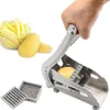 A hand is using a potato slicer to cut a potato, with cut potatoes in a bowl and whole potatoes nearby. Náhled obrázku produktu