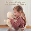 A young girl is hugging a plush toy. Produktbild-Vorschau