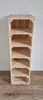 A tall, narrow shelf unit made from wooden crates against a white wall and on a wooden floor. Produktbild-Vorschau