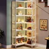 A white corner shelving unit filled with various items, including bottles, jars, and decorative objects, with integrated lighting. Anteprima dell’immagine prodotto