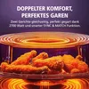 Close-up of fried chicken in an air fryer with glowing heating elements above. Produktbild-Vorschau