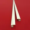 Two white plastic strips are laid diagonally on a red background. Produktbild-Vorschau