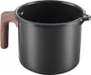 A black pot with a wooden handle and measurement markings on the side, isolated on a white background. Produktbild-Vorschau