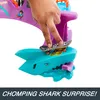 A close-up shot of a toy skateboard set with a shark-themed ramp, featuring a hand operating a miniature skateboard. Náhled obrázku produktu