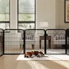 A beagle puppy sleeps on a rug in front of a black metal pet playpen in a living room. Podgląd zdjęcia produktu