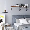 A bedroom scene with a wall shelf above a bed. Produktbild-Vorschau