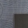 A close-up view of a gray rug with a geometric pattern and its textured backing. Anteprima dell’immagine prodotto