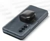 A gray Samsung phone case with a black charging case for earbuds placed on top. Náhled obrázku produktu