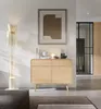 A modern living room with a wooden dresser, a floor lamp, and artwork on the wall. Produktbild-Vorschau