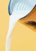 Coconut milk being poured from a can. Produktbild-Vorschau