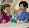 Two children are playing with Play-Doh dinosaur toys on a table. Náhled obrázku produktu