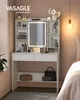 A white vanity table with a lighted mirror and shelves filled with makeup and accessories, placed in a bedroom setting next to a bed. Produktbild-Vorschau