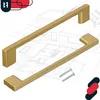 Two gold cabinet handles are displayed diagonally over a blueprint background, with screws shown near one of the handles. Produktbild-Vorschau