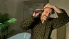 A man is trimming his beard in a bathroom. Produktbild-Vorschau