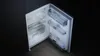 An open refrigerator with empty shelves and compartments. Produktbild-Vorschau