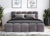 A bedroom setting with a bed, pillows, and plants. Produktbild-Vorschau