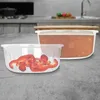 Two food storage containers are shown on a countertop, one filled with red pepper slices and the other with a reddish-orange food item. Produktbild-Vorschau