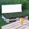 Outdoor seating area with pallet furniture and cushions. Anteprima dell’immagine prodotto