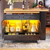 A kitchen island with storage and lighting, displaying various items like bottles, appliances, and bowls. Produktbild-Vorschau