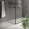 A modern, minimalist bathroom with a sleek shower drain and a towel hanging on a rack. Náhľad obrázku produktu