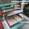 A modern bedroom with a bed featuring integrated storage and LED lighting. Produktbild-Vorschau
