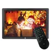 A digital photo frame displaying a Christmas scene with two children opening a gift, with a remote control in the foreground. Podgląd zdjęcia produktu