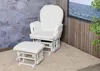 A cream-colored glider chair and ottoman set with a white frame, placed on a beige carpet in front of a stone wall and a wooden wall with a picture frame. Anteprima dell’immagine prodotto