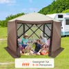 A family and their dog are enjoying themselves inside a pop-up gazebo in a grassy outdoor setting, with a camper van in the background. Podgląd zdjęcia produktu