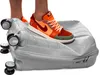 A person's feet wearing colorful sneakers are stepping on a gray suitcase, crushing it. Podgląd zdjęcia produktu