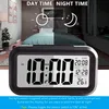 A digital alarm clock is shown in the foreground, with a split image of a bedroom in the background, representing day and night. Anteprima dell’immagine prodotto