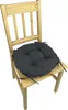 A round, dark gray seat cushion with ties is placed on a light wooden chair. Produktbild-Vorschau