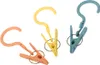 Three colorful clothes clips with hooks are arranged on a white background. Anteprima dell’immagine prodotto