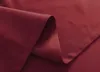A close-up view of folded burgundy fabric, likely a curtain, showing its texture and stitching. Produktbild-Vorschau