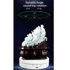 A white rotating display stand with a decorative white sculpture on top, set against a dark background with marketing text and diagrams. Náhled obrázku produktu