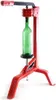 A red bottle capper with a green bottle inserted. Anteprima dell’immagine prodotto