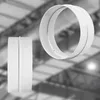 Two white circular duct connectors are shown against a blurred industrial background. Náhľad obrázku produktu