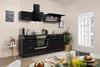 A modern black kitchen unit with appliances and a window in the background.