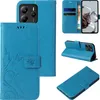 A collage of images showing a blue flip phone case with floral and butterfly designs from different angles. Produktbild-Vorschau