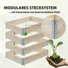 A modular wooden raised garden bed system is shown stacked, with a close-up of the metal hinges and a hand holding a seedling. Produktbild-Vorschau