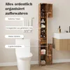 A tall, narrow bathroom cabinet is shown next to a toilet and a sink. Podgląd zdjęcia produktu