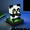 A Minecraft-themed panda desk lamp sits on a desk next to some books and a keyboard. Náhled obrázku produktu