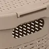 A close-up view of a beige plastic laundry basket, showing the texture and a handle. Podgląd zdjęcia produktu