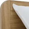 A close-up view of a wooden bed frame with a white pillow. Produktbild-Vorschau