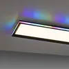 A close-up shot of a rectangular LED ceiling light with RGB and CCT color-changing capabilities, casting colorful light onto the ceiling. Produktbild-Vorschau