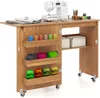 A sewing table with a sewing machine and various sewing supplies. Podgląd zdjęcia produktu