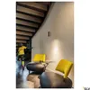 A modern interior scene with a staircase, seating area, and a mannequin. Produktbild-Vorschau