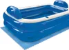 An inflatable blue and white pool with a blue mat underneath, shown from a diagonal angle on a white background. Produktbild-Vorschau