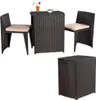 A set of outdoor furniture including two chairs, a table, and a storage stool, all made of dark brown rattan with beige cushions. Anteprima dell’immagine prodotto