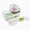 A set of clear plastic food storage containers with blue lids, some containing food items like salad, cherries, and kiwi slices. Produktbild-Vorschau
